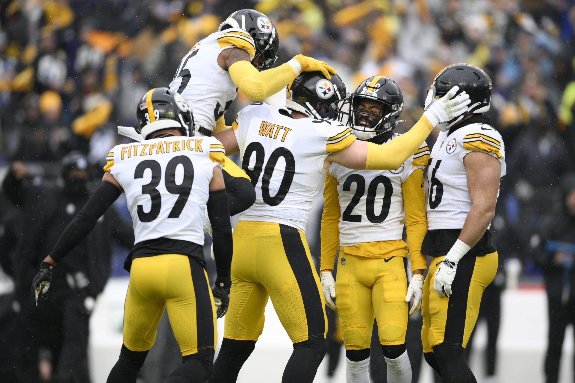 Pittsburgh Steelers outside linebacker T.J. Watt (90) celebrates with teammates, from left, free safety Minkah Fitzpatrick (39), cornerback Arthur Maulet (35), cornerback Cameron Sutton (20) and outside linebacker Alex Highsmith (56) after recording a forced fumble against Baltimore Ravens quarterback Tyler Huntley during the first half of an NFL football game, Sunday, Jan. 9, 2022, in Baltimore.