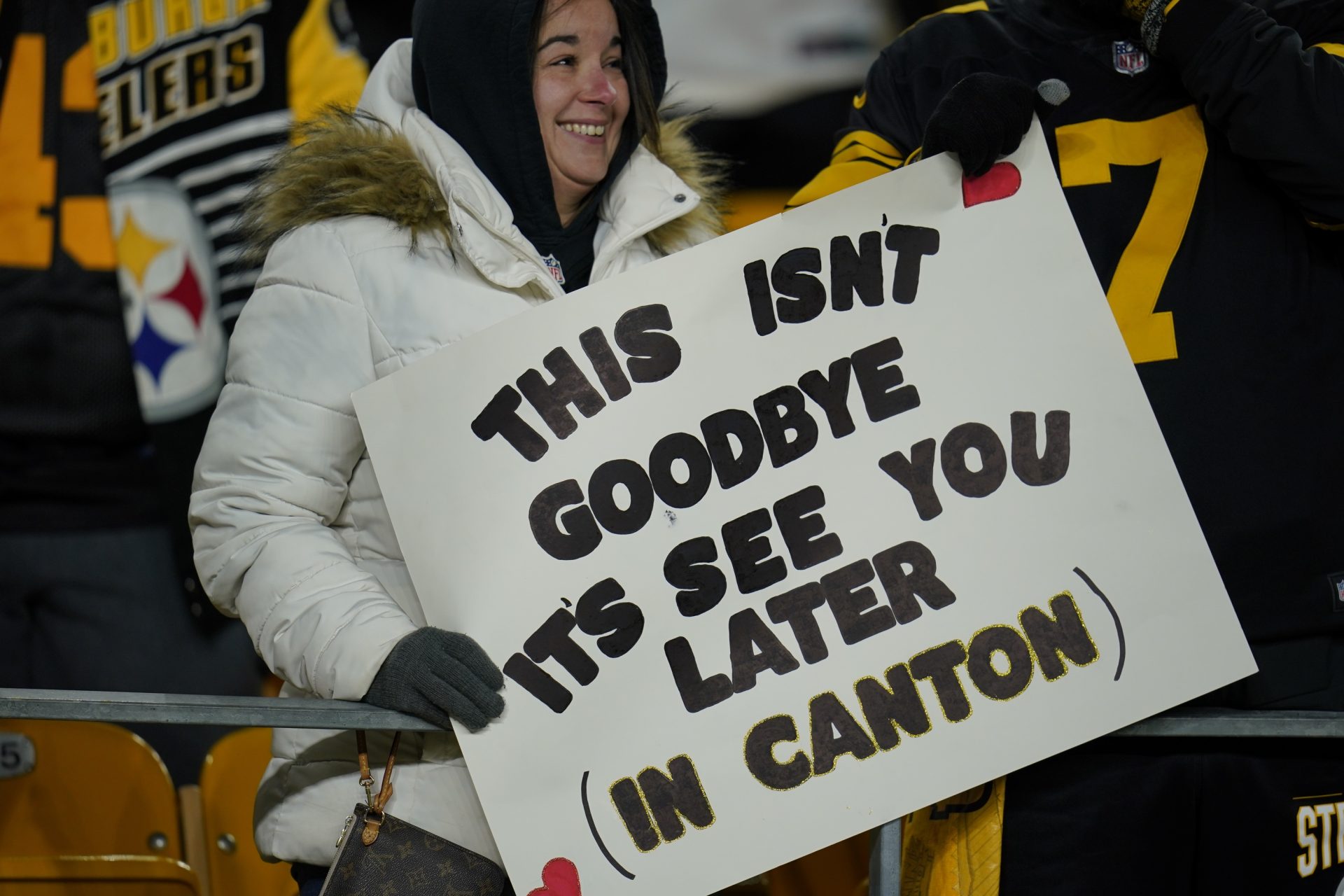 A Pittsburgh Steelers fan holds a sign for quarterback Ben Roethlisberger at Heinz Field as the teams warms up before an NFL football game against the Cleveland Browns, Monday, Jan. 3, 2022, in Pittsburgh.