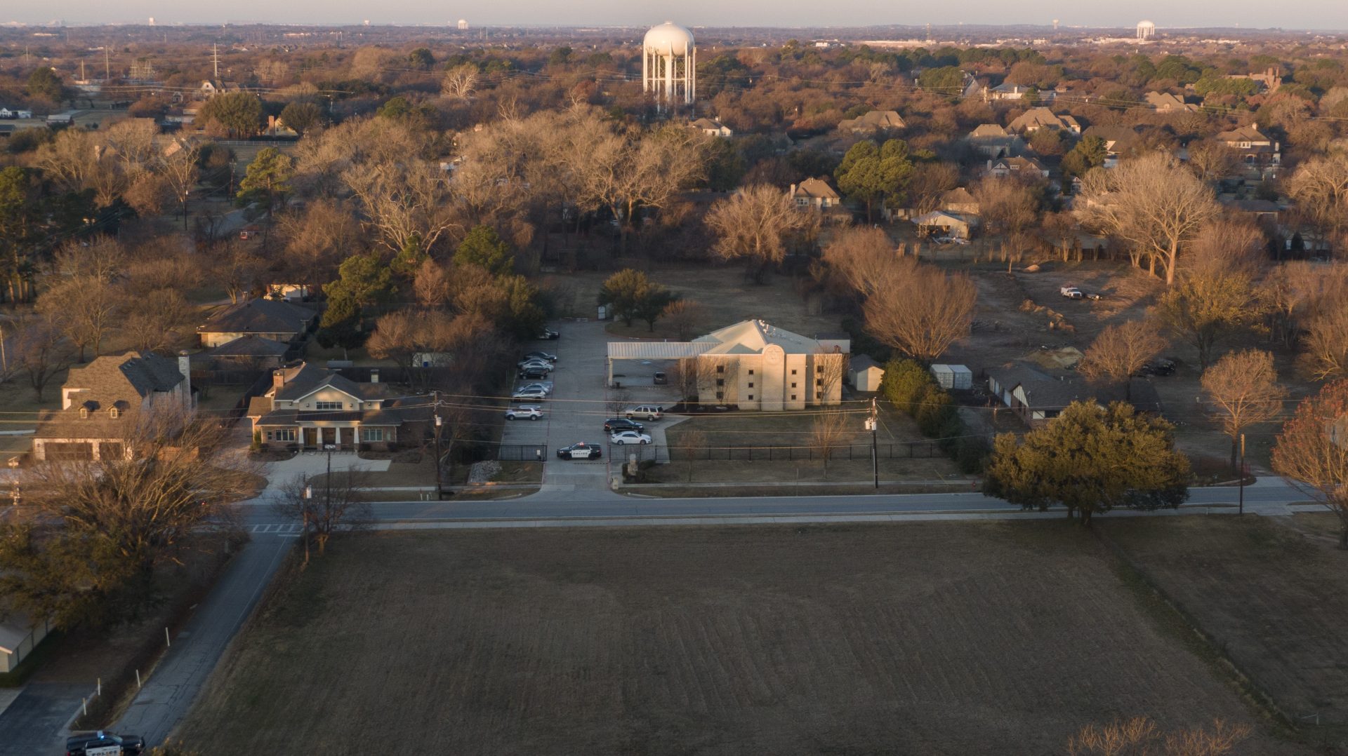 An aerial view of police standing in front of the Congregation Beth Israel synagogue, Sunday, Jan. 16, 2022, in Colleyville, Texas.