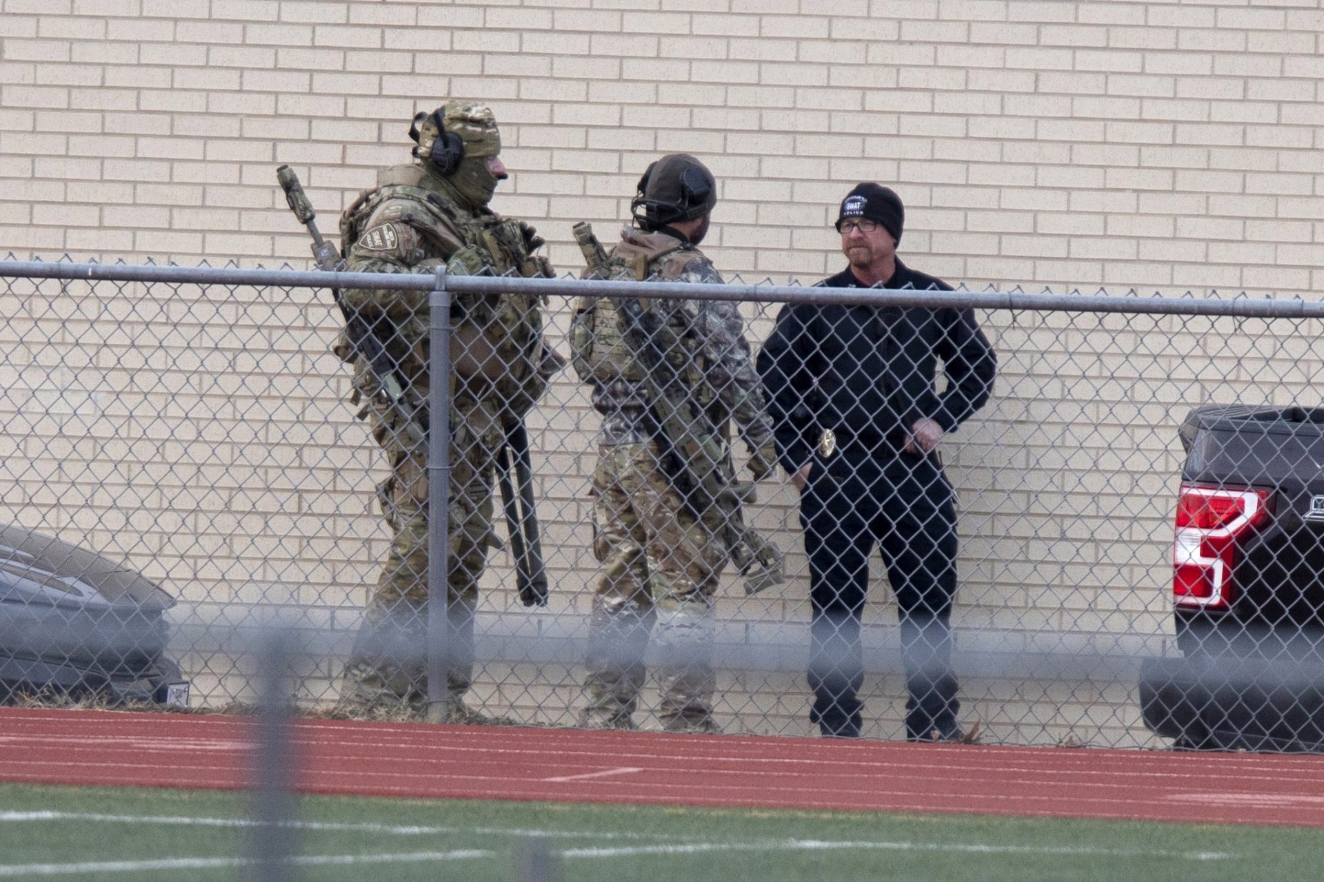 Law enforcement officials gather at a local school near the Congregation Beth Israel synagogue on Saturday, Jan. 15, 2022 in Colleyville, Texas