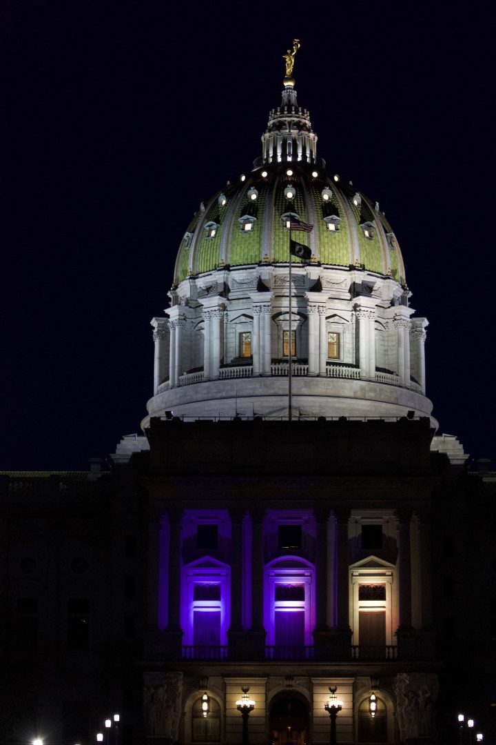 The Pennsylvania Capitol is lit at night in the yellow and blue colors of the Ukrainian flag in solidarity with Ukraine amid the Russian invasion, Monday, Feb. 26, 2022, in Harrisburg, Pa. (AP Photo/Marc Levy)