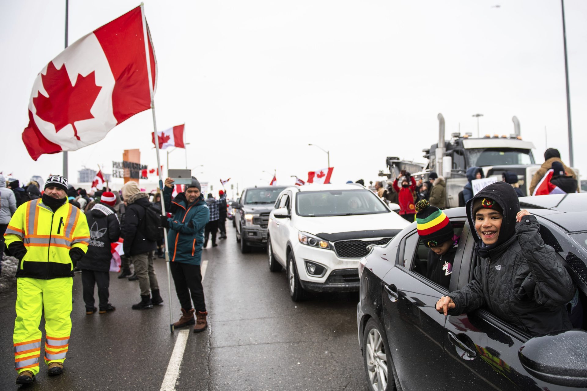 Protestors show their support for the Freedom Convoy of truck drivers who are making their way to Ottawa to protest against COVID-19 vaccine mandates by the Canadian government on Thursday, Jan. 27, 2022, in Vaughan.