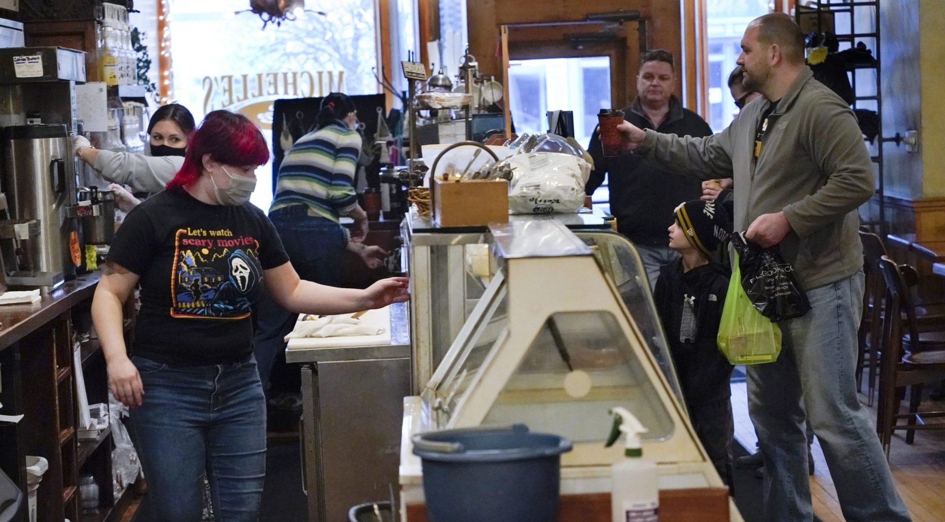 People get their orders at the counter of Michelle's Cafe along Main Street, in Clarion, Pa., Saturday, Feb. 12, 2022. (