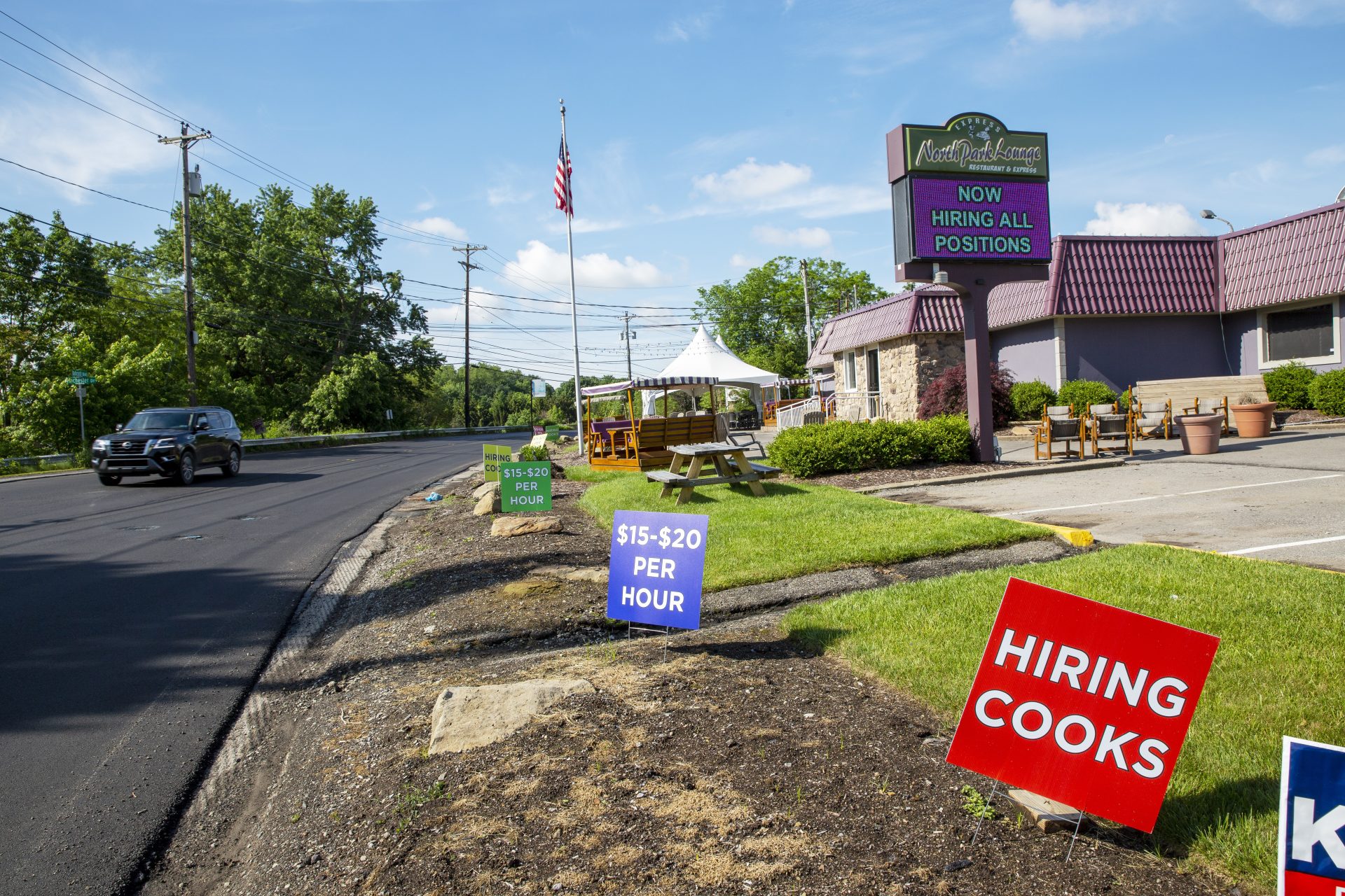 Several hiring signs are outside a restaurant in McCandless Township, Pennsylvania, on Monday, May 31, 2021.