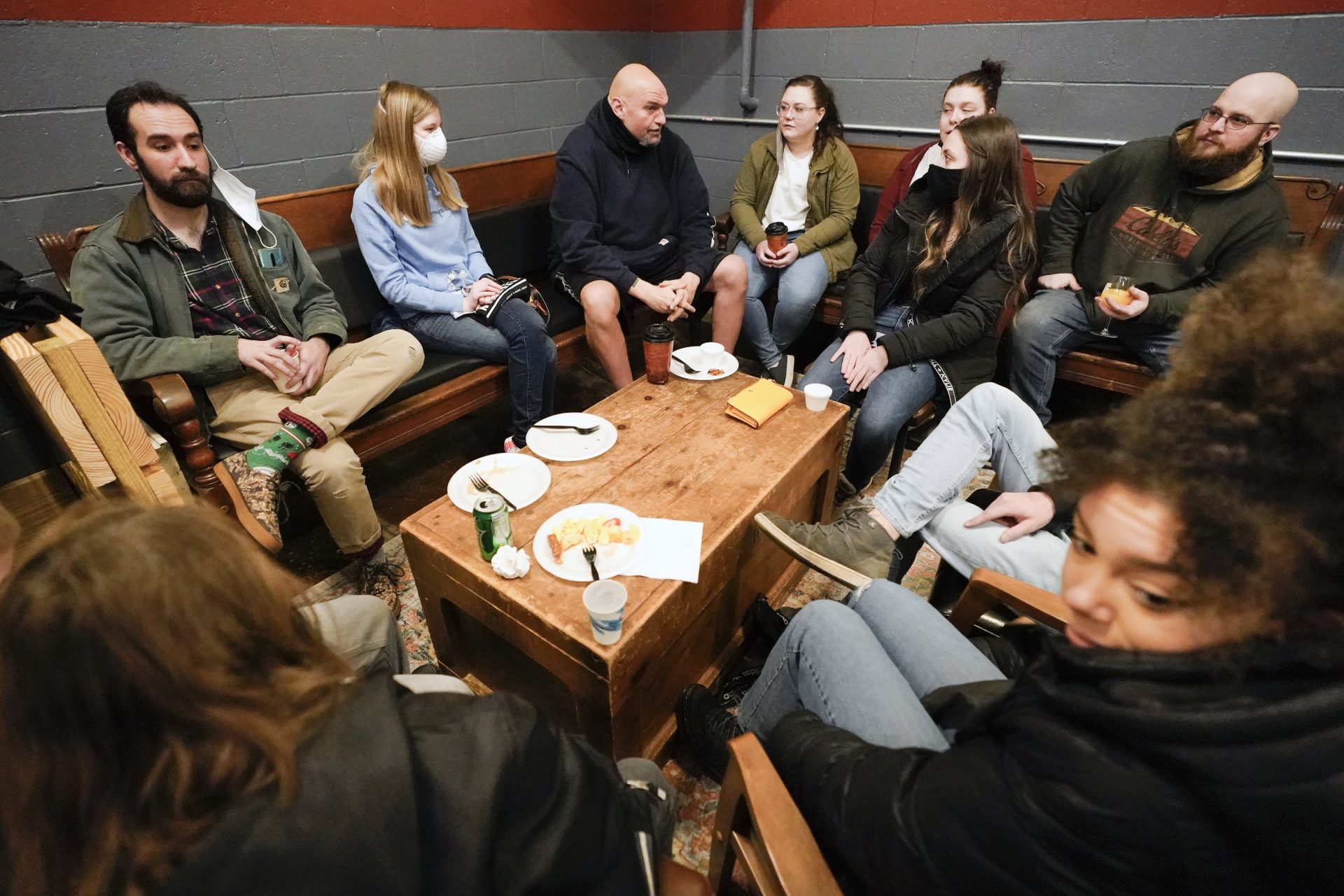 Democratic candidate for the Pennsylvania U.S.senate seat in the 2022 primary election, Lt. Gov. John Fetterman, center, talks with people during a campaign stop at the Mechanistic Brewery, in Clarion, Pa., Saturday, Feb. 12, 2022.