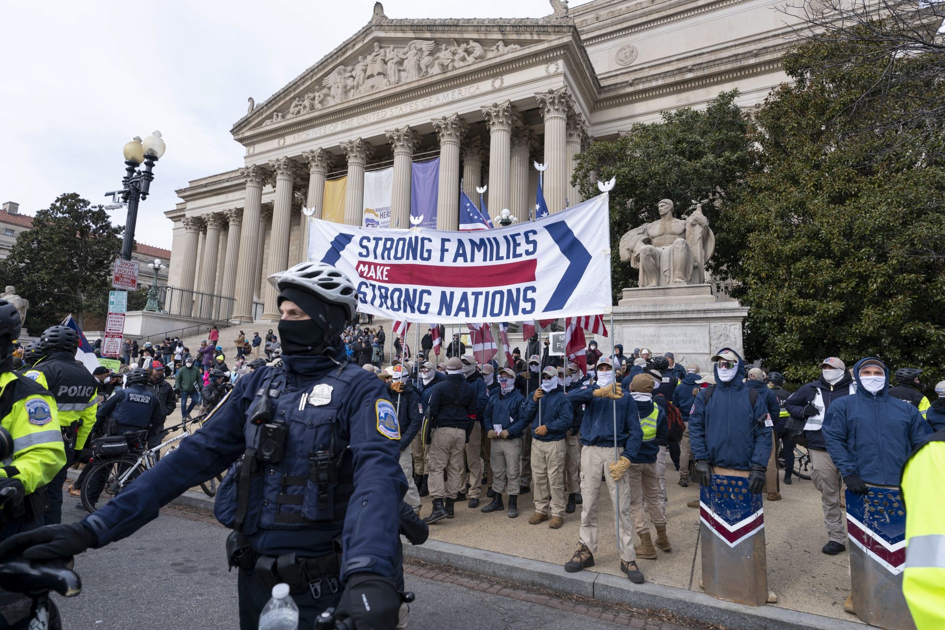 Members of the white supremacist group Patriot Front march on Constitution Avenue near the National Archives in Washington, Friday, Jan. 21, 2022.