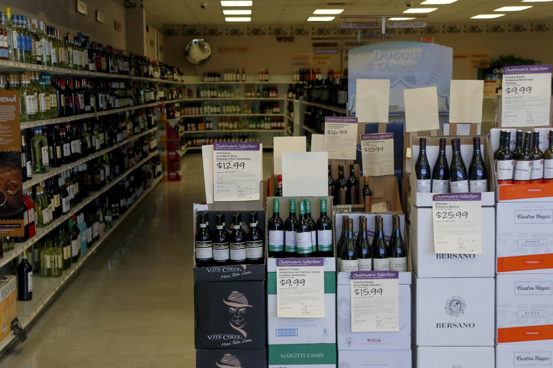 Shelves of merchandise at the Pennsylvania Wine and Liquor store in Seven Fields, Pa, are seen through the window Monday, April 20, 2020.