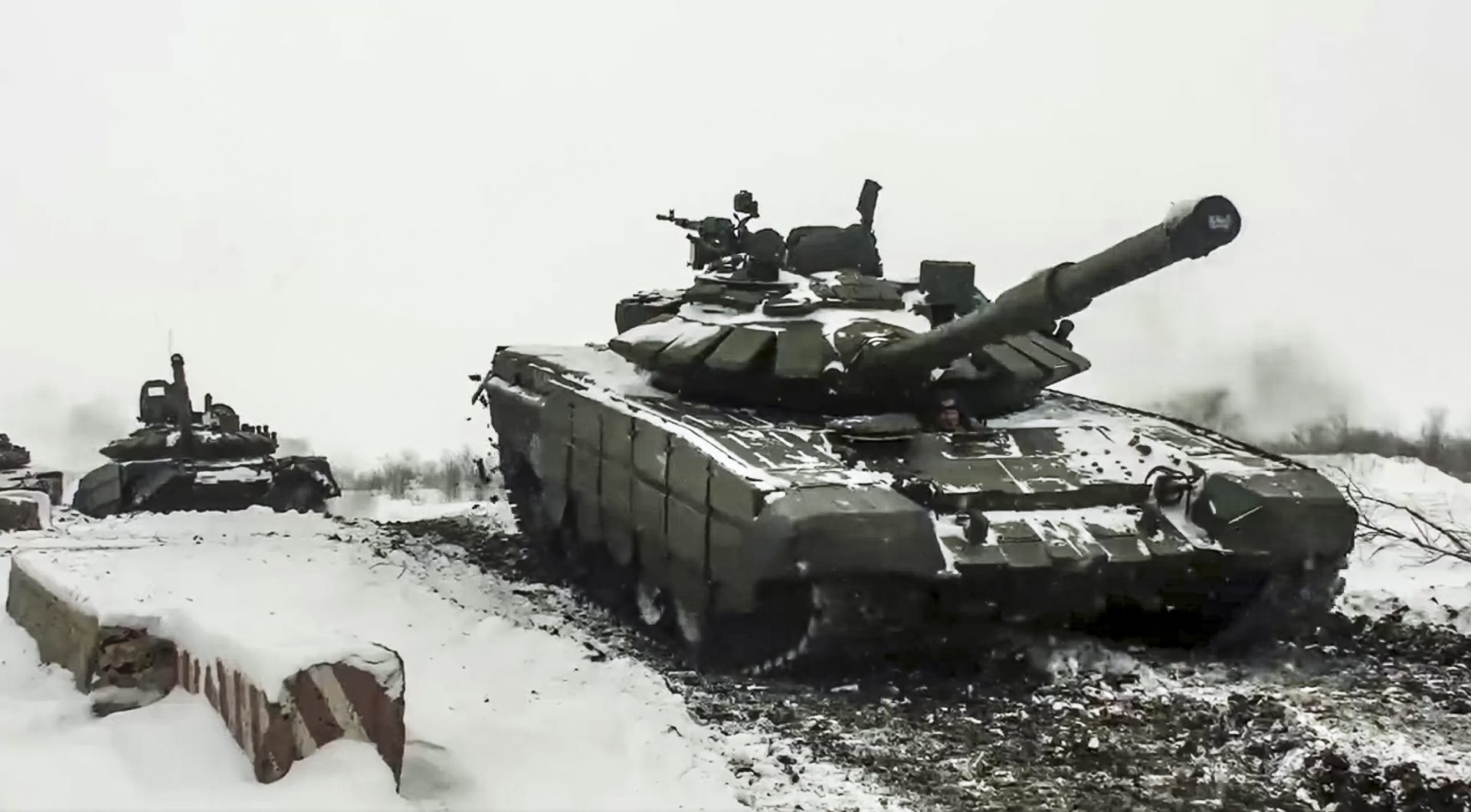 In this grab taken from video provided by the Russian Defense Ministry Press Service on Wednesday, Jan. 26, 2022, a Russian tanks roll during a military exercising at a training ground in Rostov region, Russia.