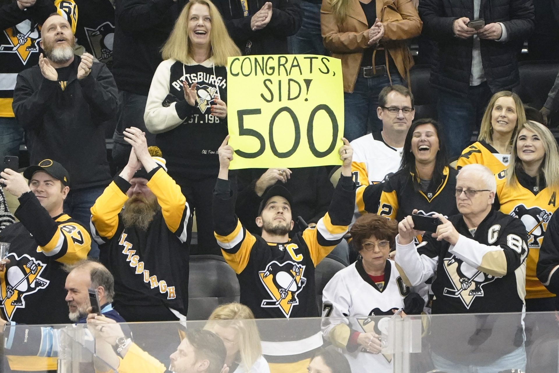 A fan holds up a sign recognizing the 500th goal after Pittsburgh Penguins' Sidney Crosby, (87) scored his 500th NHL career goal against the Philadelphia Flyers, during the first period of an NHL hockey game, Tuesday, Feb. 15, 2022, in Pittsburgh.