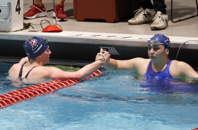 Pennsylvania's Lia Thomas, left, shakes hands with teammate Anna Sofia Kalandadze after Thomas finished first in the 500-yard freestyle final at the Ivy League women's swimming and diving championships at Harvard University, Thursday, Feb. 17, 2022, in Cambridge, Mass.