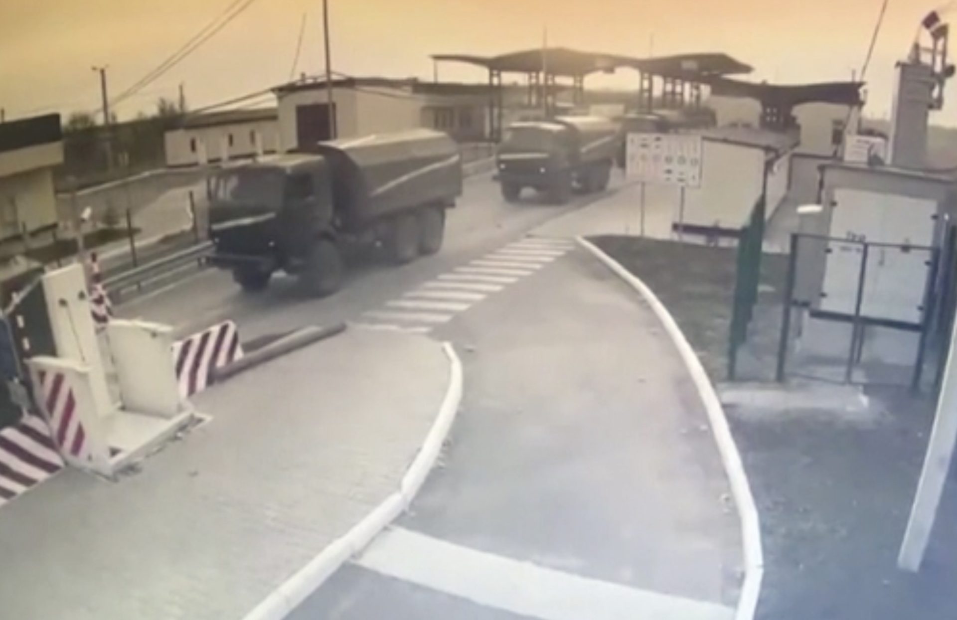 In this image made from video provided by the Border Service of Ukraine, military vehicles pass a control point at the Armyansk checkpoint at the Ukraine-Crimea border, Thursday, Feb. 24, 2022.