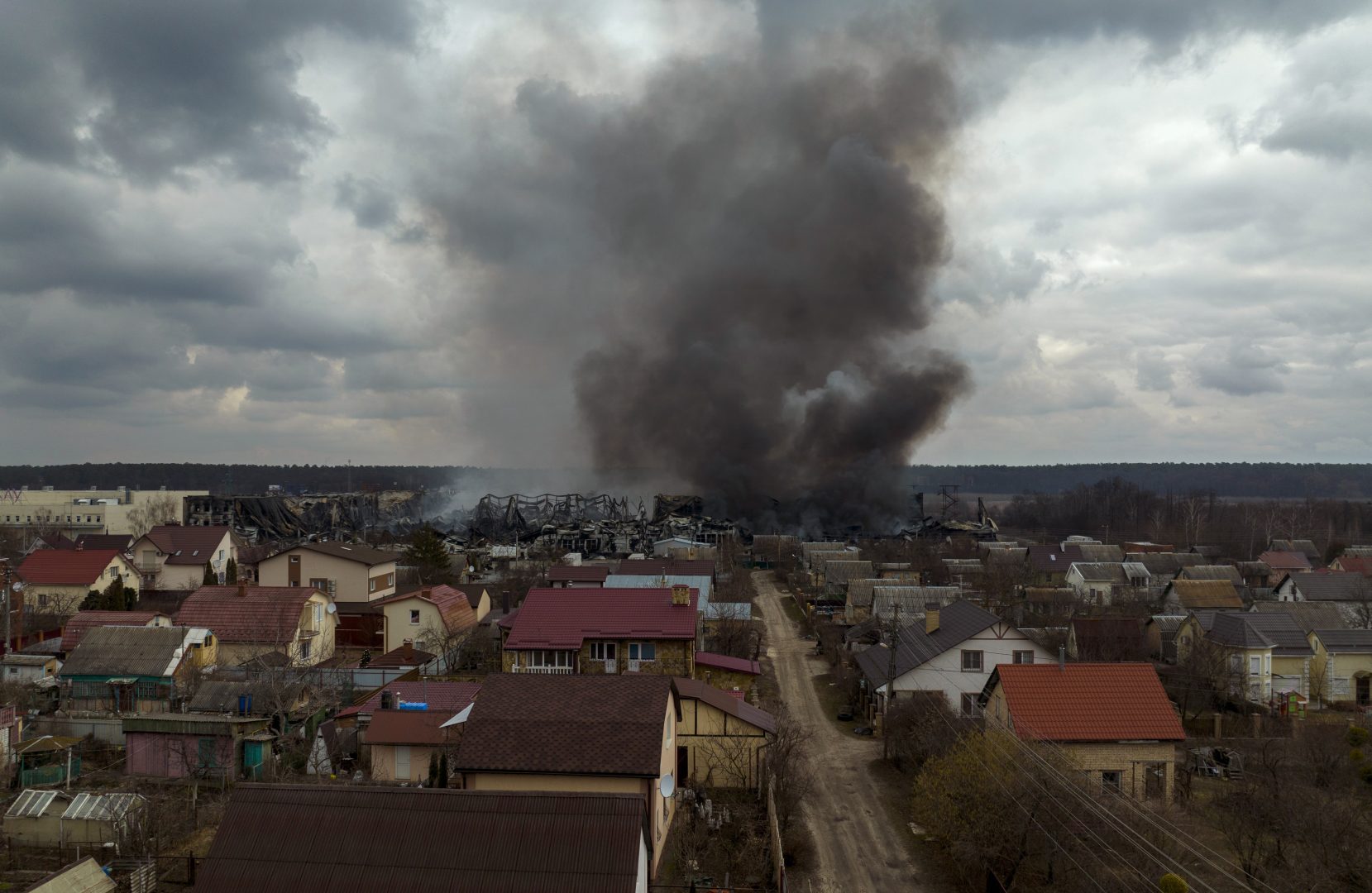 A factory and a store burn after being bombarded in Irpin, on the outskirts of Kyiv, Ukraine, Sunday, March 6, 2022. (AP Photo/Emilio Morenatti)