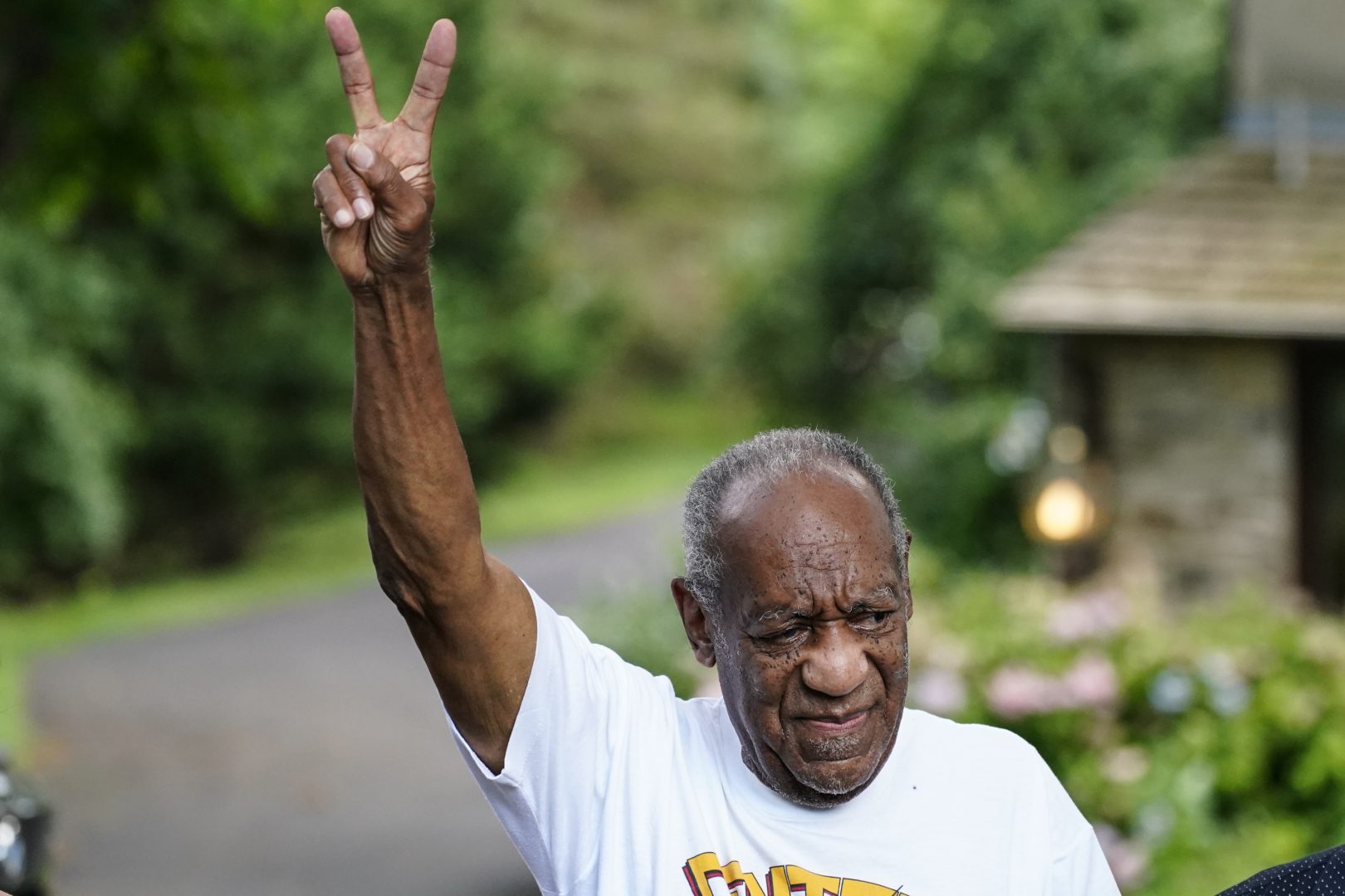 FILE - This June 30, 2021, file photo shows Bill Cosby gesturing outside his home in Elkins Park, Pa., after being released from prison. The Supreme Court said Monday, March, 7, 2022, it will not take up the sexual assault case against Cosby, leaving in place a decision by Pennsylvania's highest court to throw out his conviction and set him free from prison. The high court declined prosecutors' request to hear the case and reinstate Cosby's conviction. The Pennsylvania Supreme Court last year threw out Cosby's conviction, saying the prosecutor who brought the case was bound by his predecessor's agreement not to charge Cosby. (AP Photo/Matt Rourke, File)