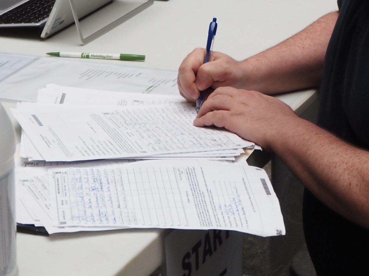 A worker for Republican gubernatorial candidate Dave White signs the last stack of petitions for the campaign at a Department of  State collection site in Harrisburg on March 15, 2022.