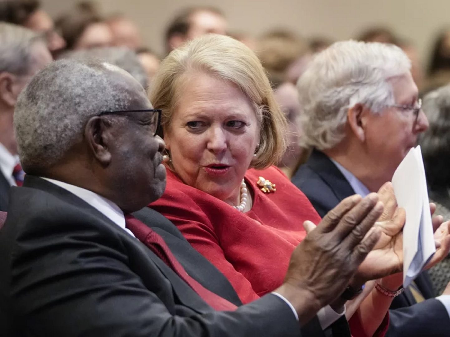 Supreme Court Justice Clarence Thomas talks to his wife, Ginny Thomas, a conservative activist, at the Heritage Foundation on Oct. 21, 2021, in Washington, D.C.
