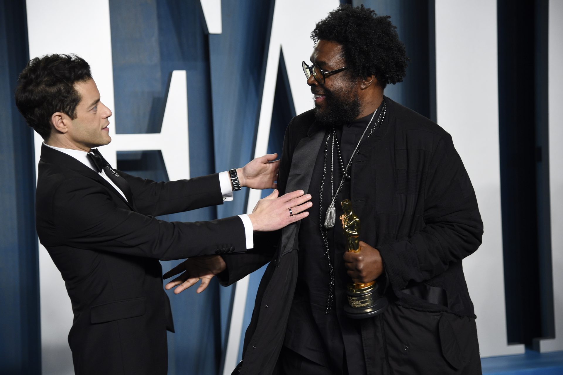 Rami Malek, left, and Questlove arrive at the Vanity Fair Oscar Party on Sunday, March 27, 2022, at the Wallis Annenberg Center for the Performing Arts in Beverly Hills, Calif.