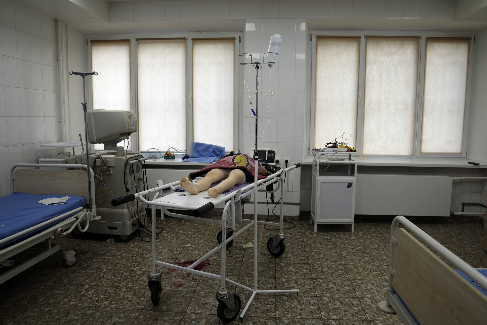 The lifeless body of a girl killed during shelling at a residential area lies on a medical cart at the city hospital of Mariupol, eastern Ukraine, Sunday, Feb. 27, 2022.