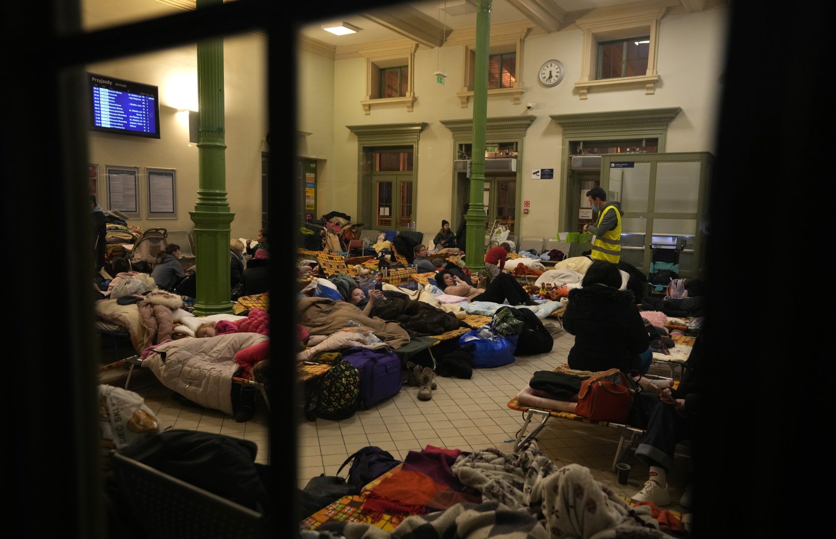 Women and children, fleeing from Ukraine, sleep at a makeshift shelter in the train station in Przemysl, Poland, Thursday, March 3, 2022. More than 1 million people have fled Ukraine following Russia's invasion in the swiftest refugee exodus in this century, the United Nations said Thursday. 