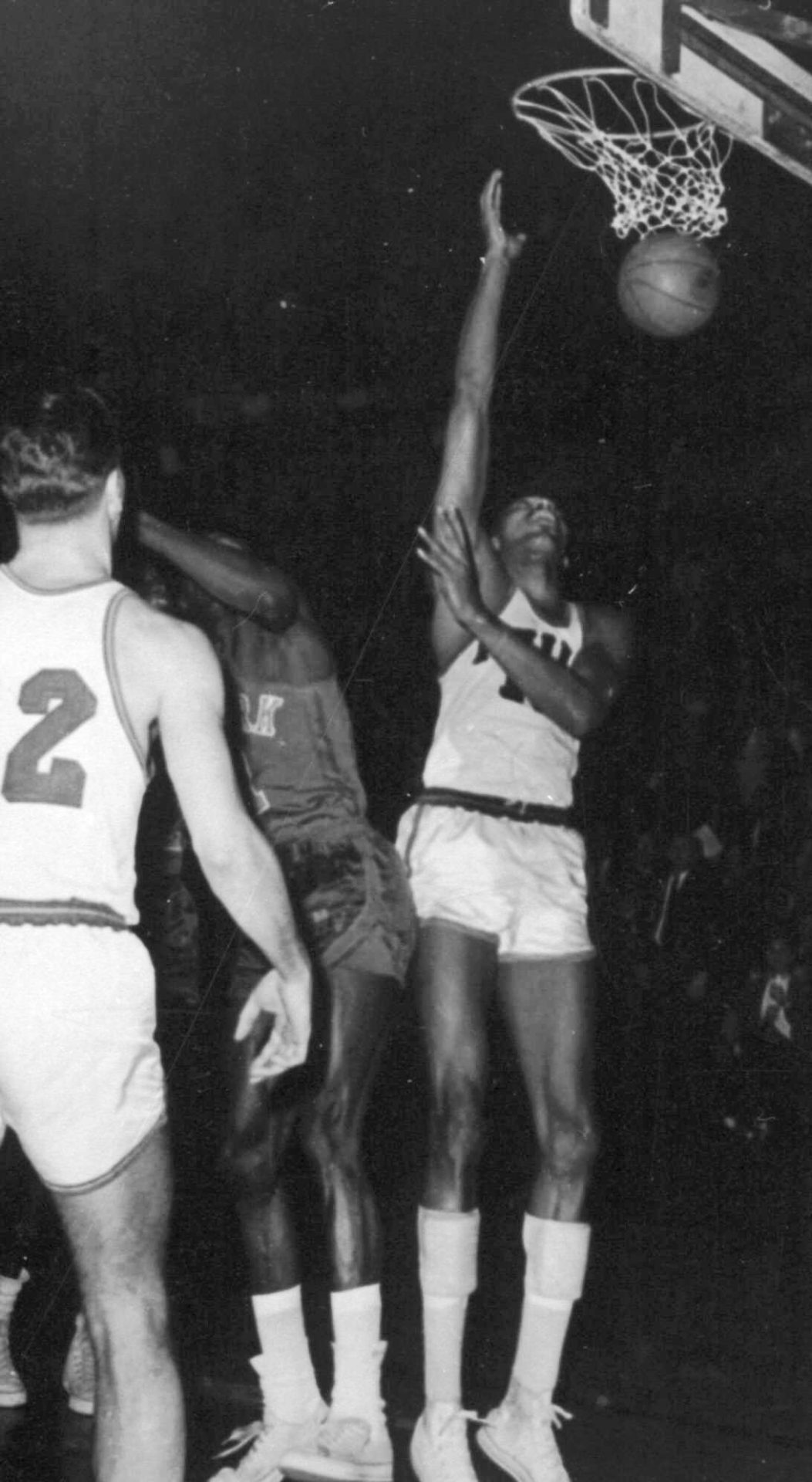 Philadelphia Warriors' Wilt Chamberlain, right, scores his 100th point, setting an NBA record, during a game against the New York Knicks in Hershey, Pa., March 2, 1962.