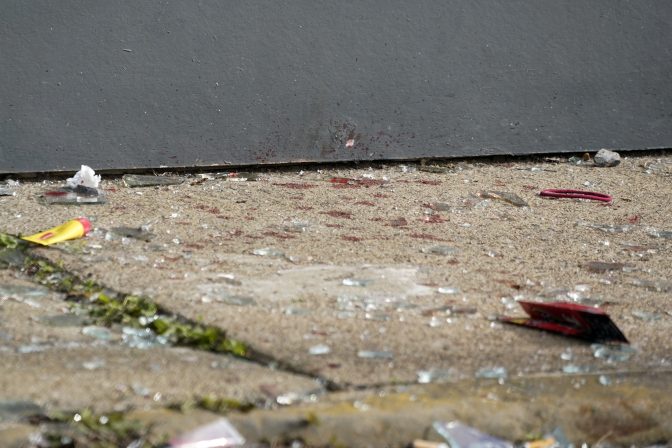 This is what appears to be blood and broken glass on the sidewalk outside the short-term rental property where police say a shooting took place at a house party in Pittsburgh early Sunday morning, April 17, 2022.