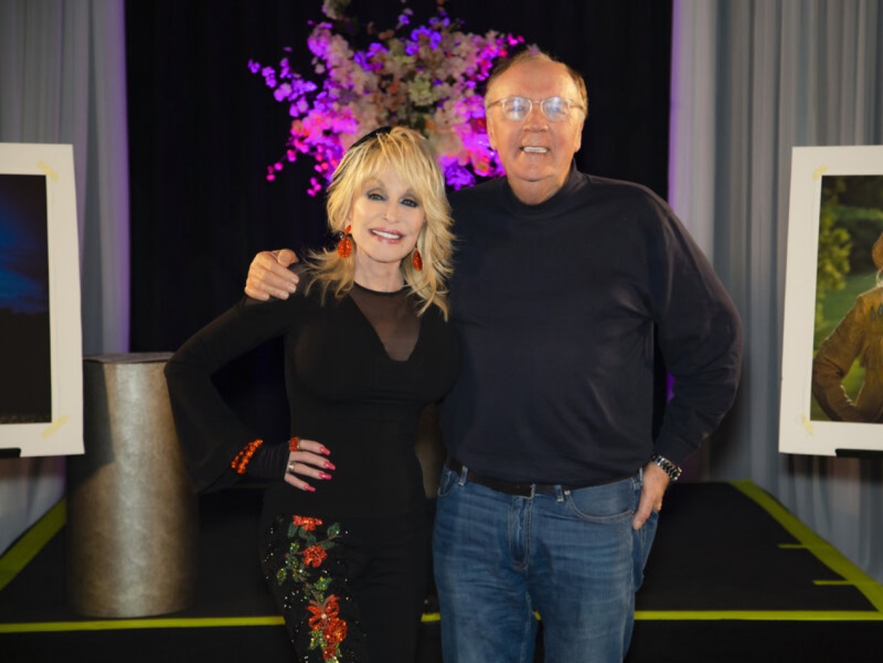 Dolly Parton and James Patterson pose for a picture in August 2021. Their new novel, Run, Rose, Run, is about an aspiring country singer in Nashville.