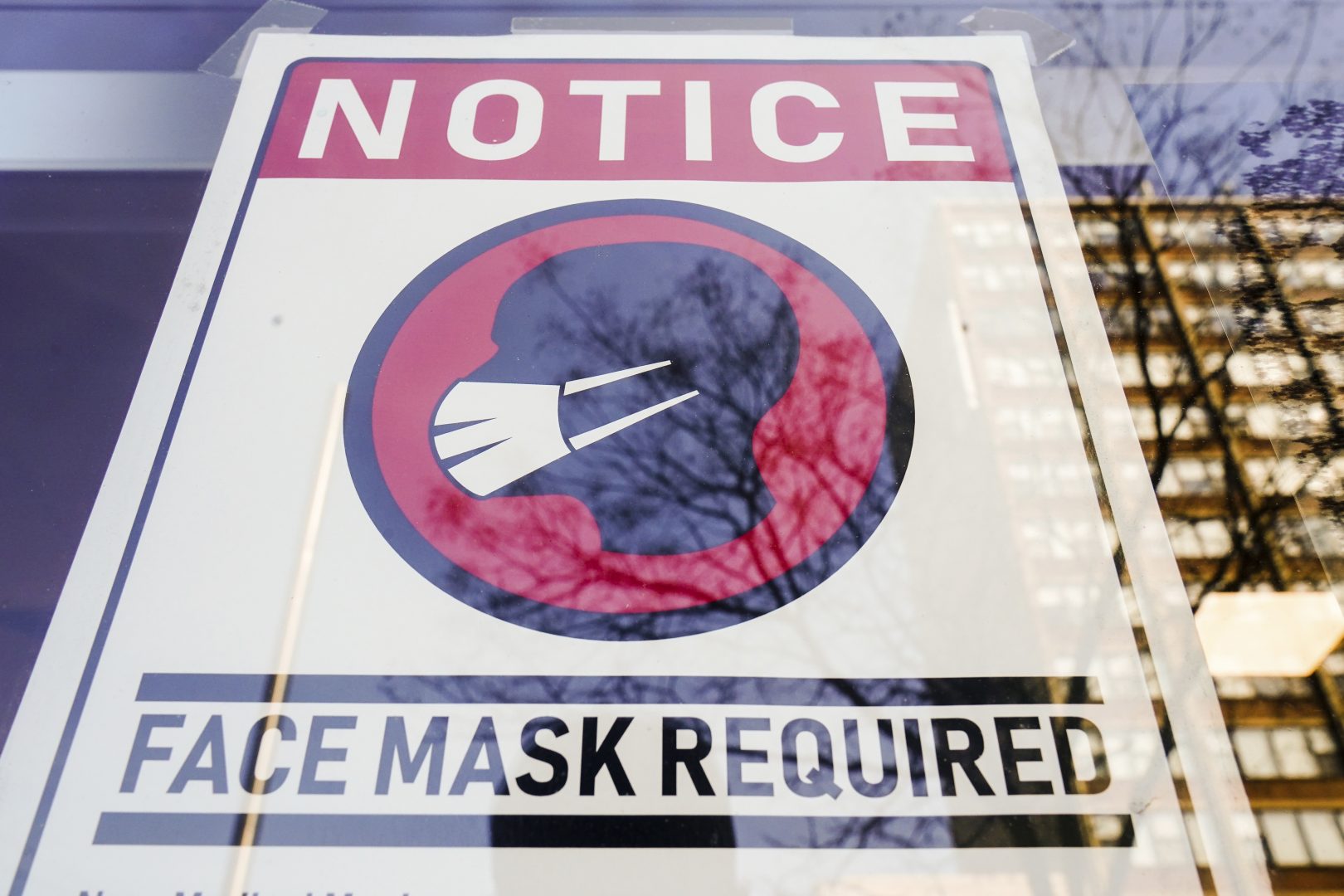 FILE - A sign requiring masks as a precaution against the spread of the coronavirus on a store front in Philadelphia, is seen Feb. 16, 2022. Philadelphia is reinstating its indoor mask mandate after reporting a sharp increase in coronavirus infections, Dr. Cheryl Bettigole, the city's top health official, announced Monday, April 11, 2022. Confirmed COVID-19 cases have risen more than 50% in 10 days, the threshold at which the city's guidelines call for people to wear masks indoors. (AP Photo/Matt Rourke, File)