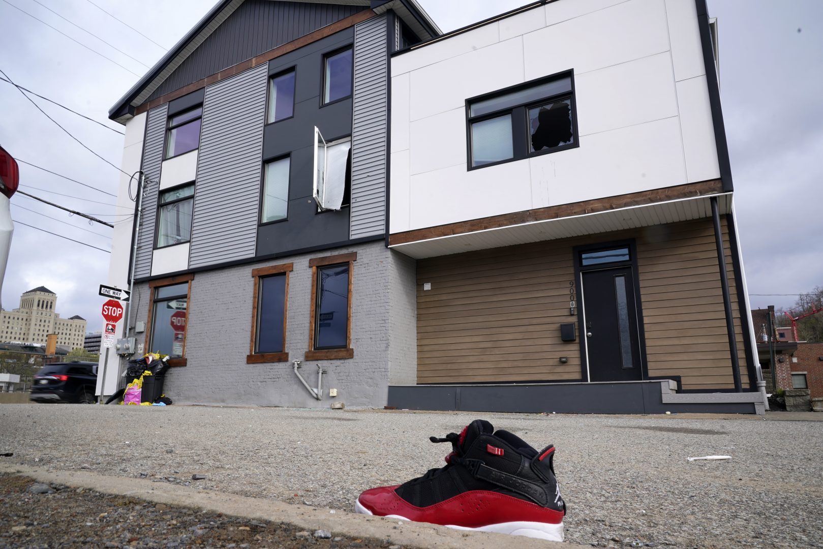 A lone sneaker lies near a short-term rental property where police say a shooting took place in Pittsburgh early Sunday morning, April 17, 2022. The shooting happened around 12:30 a.m. during a party at a short-term rental property where there were more than 200 people inside — many of them underage, Pittsburgh police said in a news release. (AP Photo/Gene J. Puskar)