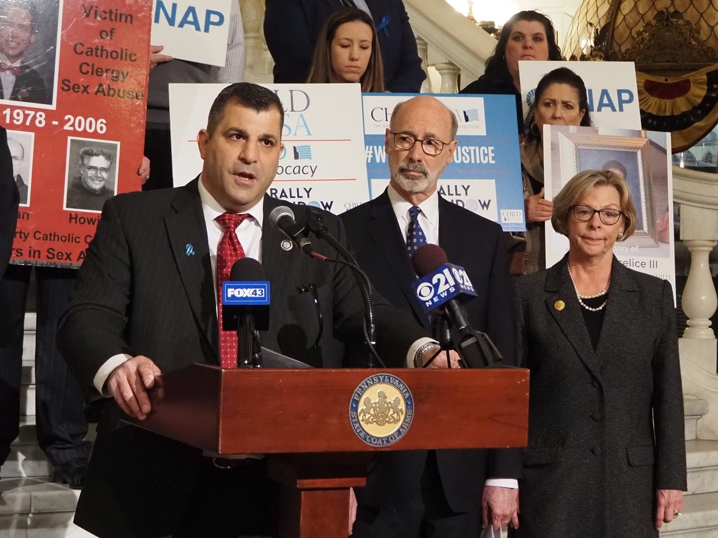 Rep. Mark Rozzi (D-Berks), left, speaks during an April 4, 2022 rally in Harrisburg on a bill that would open a new legal time window for survivors of child sexual abuse.