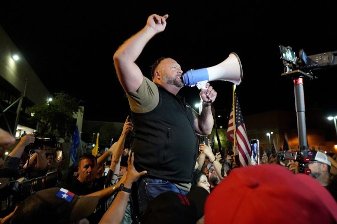 Far right radio host Alex Jones rallies supporters of President Donald Trump outside the Maricopa County Recorder's Office, Thursday, Nov. 5, 2020, in Phoenix.