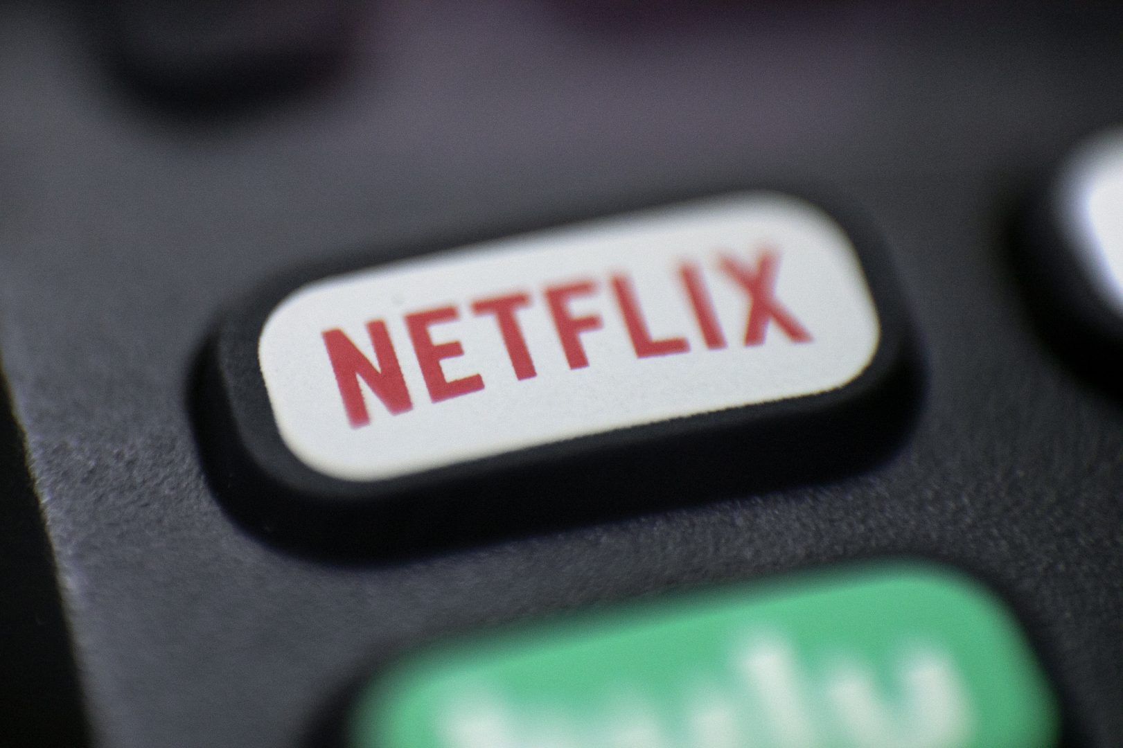 FILE - This Aug. 13, 2020 file photo shows a logo for Netflix on a remote control in Portland, Ore. Streaming services ranging from Netflix to Disney+ want us to stop sharing passwords. That's the new edict from the giants of streaming media, who hope to discourage the common practice of sharing account passwords without alienating their subscribers, who've grown accustomed to the hack.