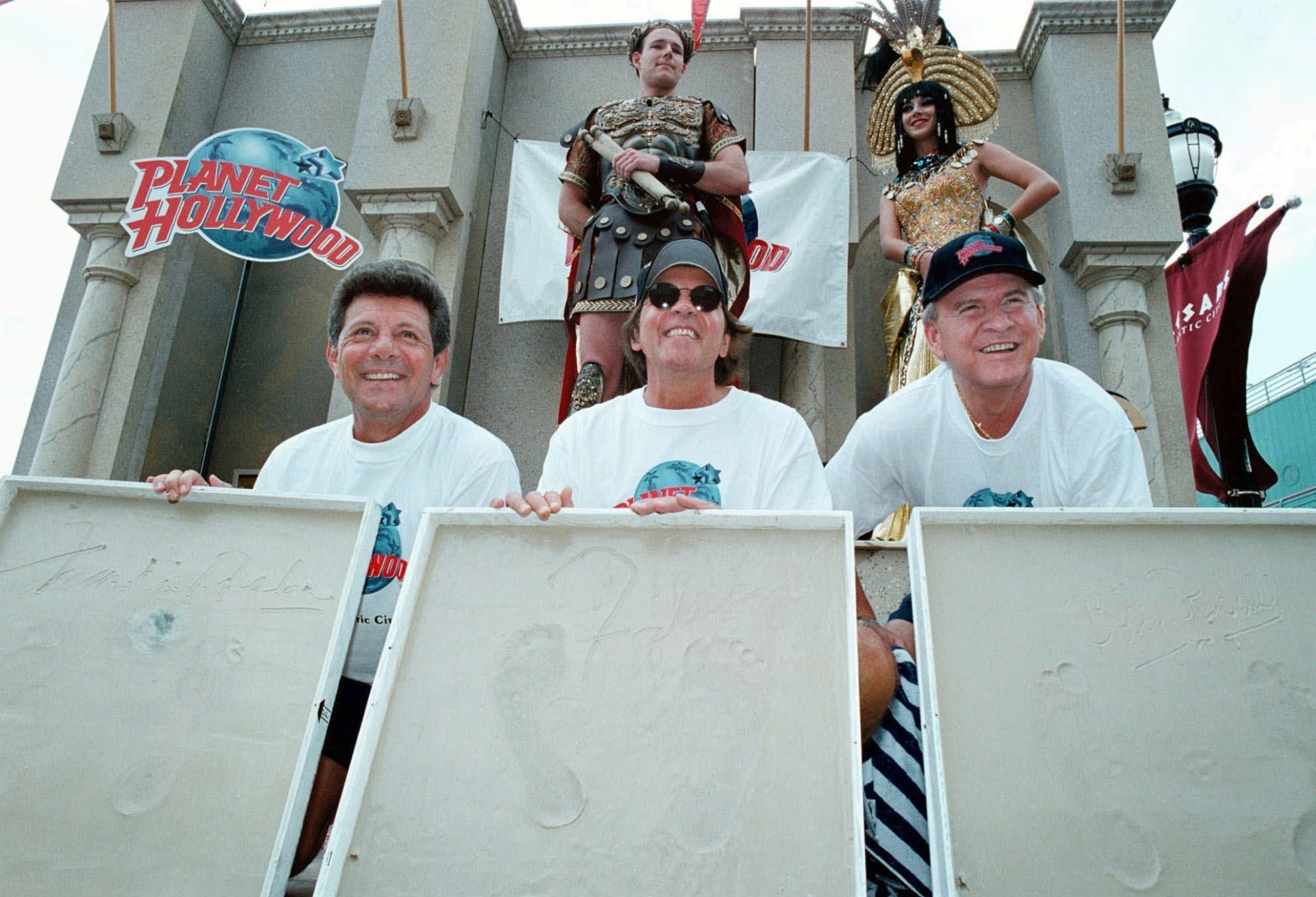Former teen idols from the 50's and 60's Frankie Avalon, left, Fabian, center, and Bobby Rydell, right, show off their foot prints in plaster casts Friday, July 3, 1998, on the Boardwalk in Atlantic City, N.J.
