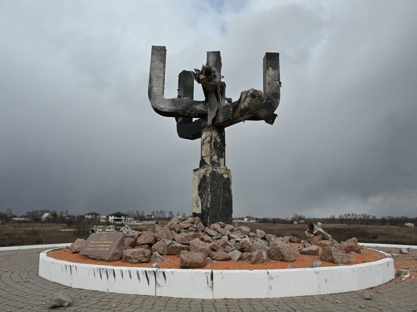 TOPSHOT - A picture taken on March 27, 2022 shows a view of the Menorah memorial, set on the place of a mass killing of Jewish people by Nazis during WWII, a day after it was damaged in a Russian shelling, at the entrance of the Drobitsky Yar Holocaust memorial complex on the eastern outskirts of Kharkiv. (Photo by Sergey BOBOK / AFP) (Photo by SERGEY BOBOK/AFP via Getty Images)