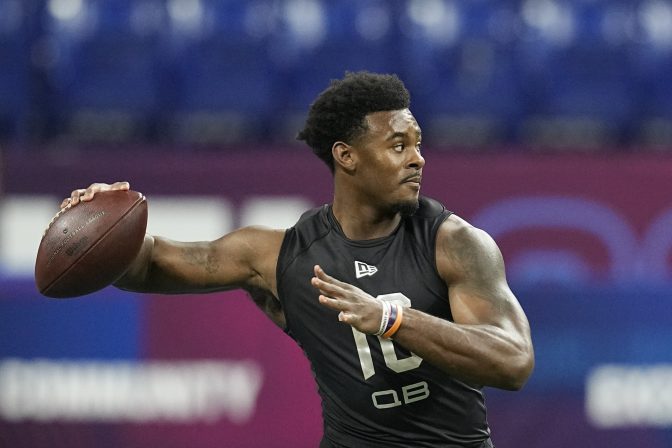 Liberty quarterback Malik Willis runs a drill during the NFL football scouting combine, Thursday, March 3, 2022, in Indianapolis.