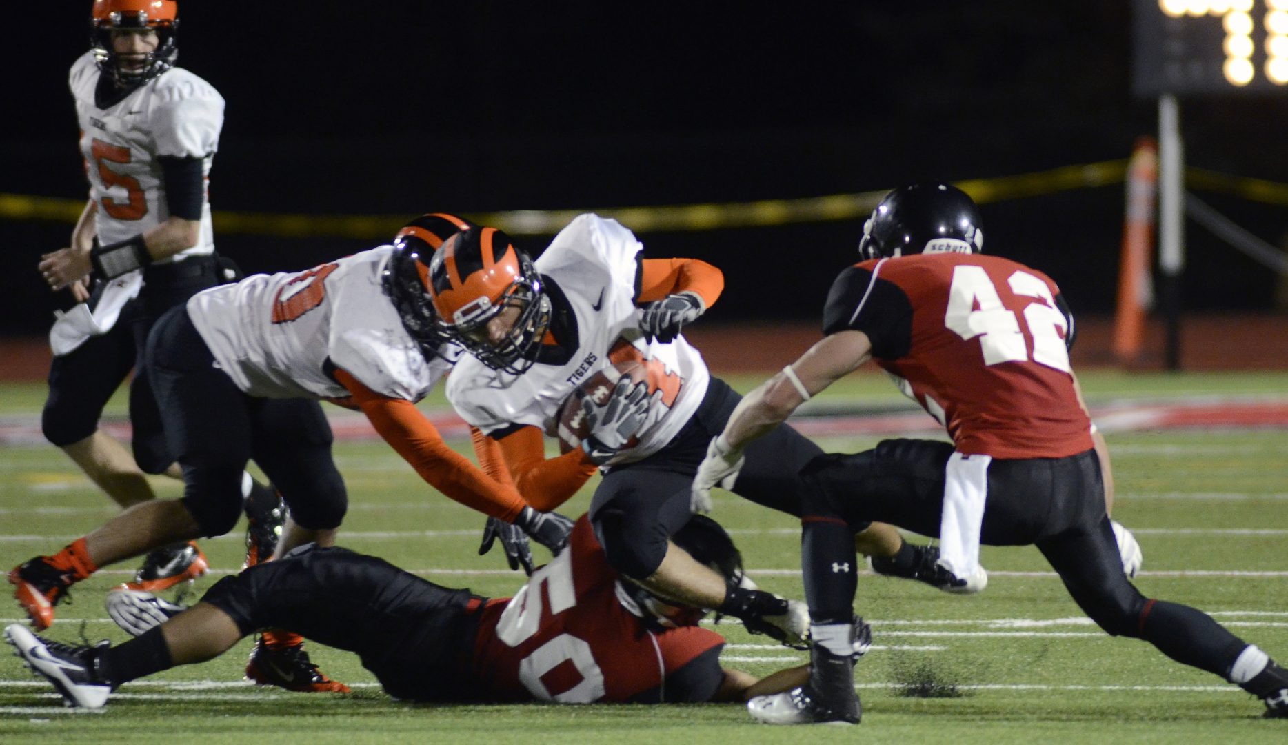 Princeton's Alex Momenee, center, picks up yardage during the second half of an NCAA college football game against Mansfield in Mansfield, Pa. on Sept. 14, 2013. 