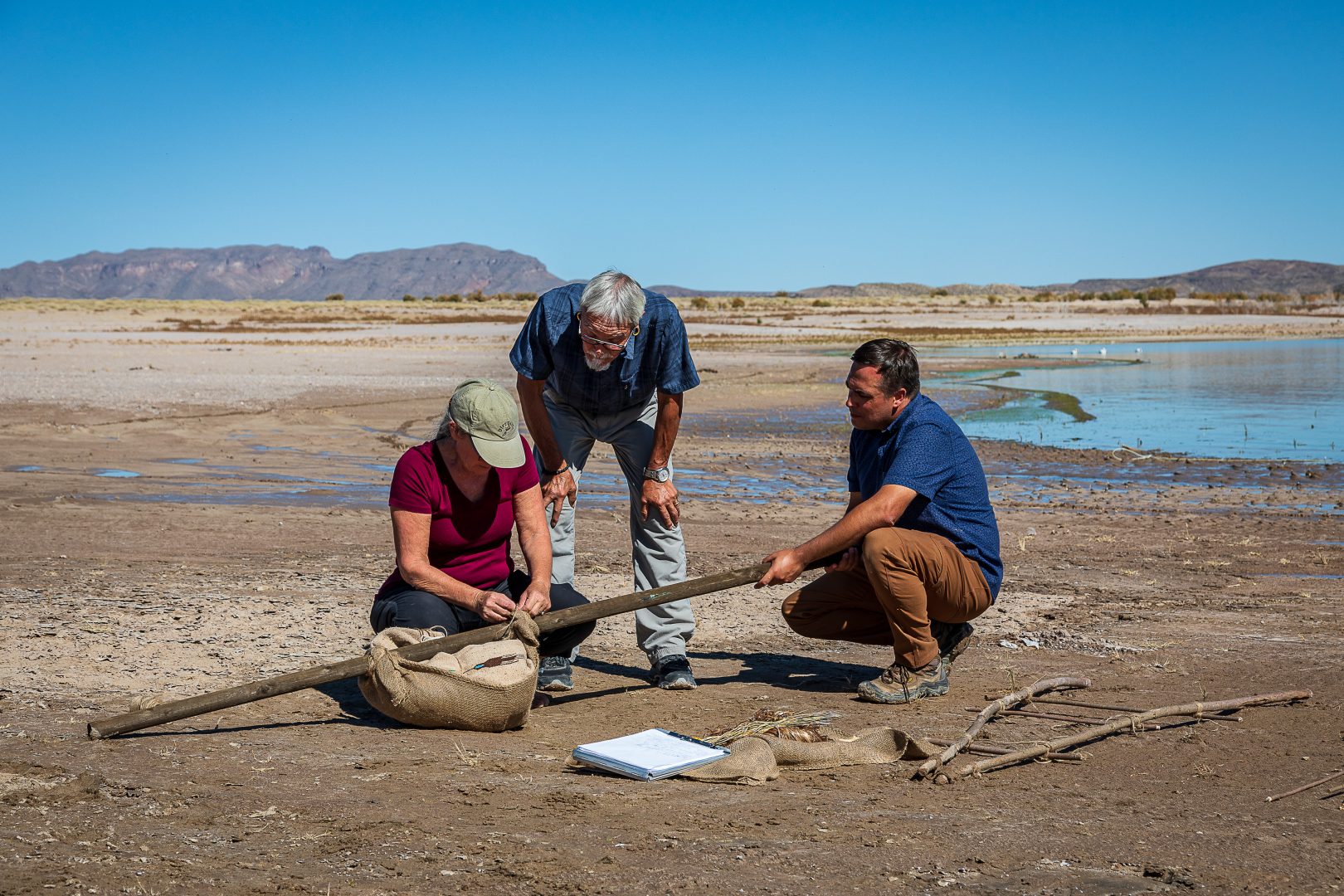 Ed Jolie, Joe Watkins and Carol Ellick build an experimental sled to see what sort of device might have made the linear drag marks at white sands.