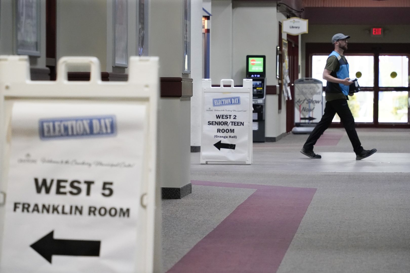 A visitor walks through the Cranberry Township Municipal Center where signs point to some of the rooms that will be used for voting in Tuesday's Pennsylvania Primary Election, Monday, May 16, 2022, in Cranberry Township, Butler County, Pa. 