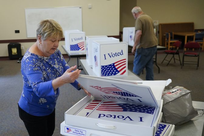 Cecelia Peterson, the majority inspector for the Cranberry West 5 voting precinct, left, and clerk Fred Peterson set up some of the folding voting booth dividers in one of the rooms in the Cranberry Township Municipal Center that will be used for voting in Tuesday's Pennsylvania Primary Election, Monday, May 16, 2022, in Cranberry Township, Butler County, Pa.