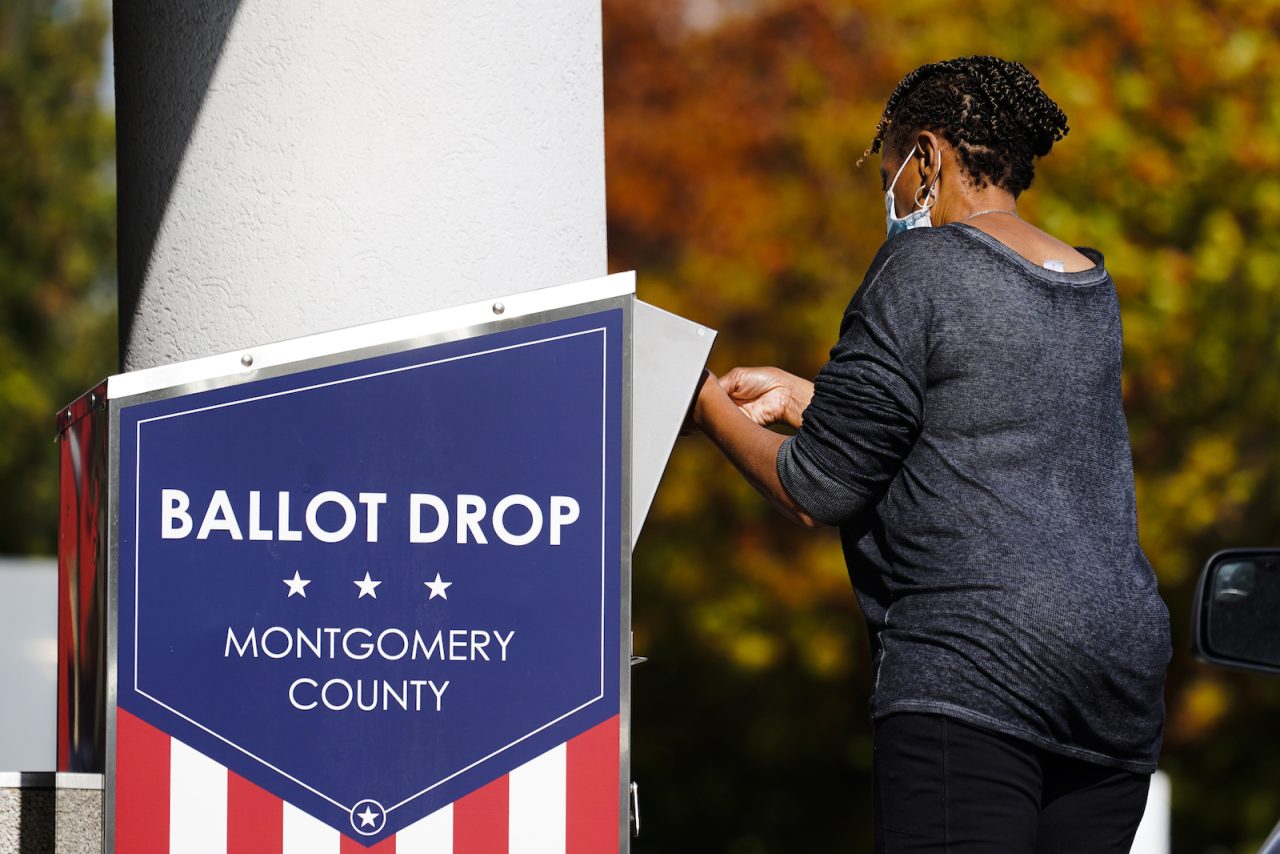 A person drops off a mail-in ballot at an election ballot return box in Willow Grove, Pa., Monday, Oct. 25, 2021.