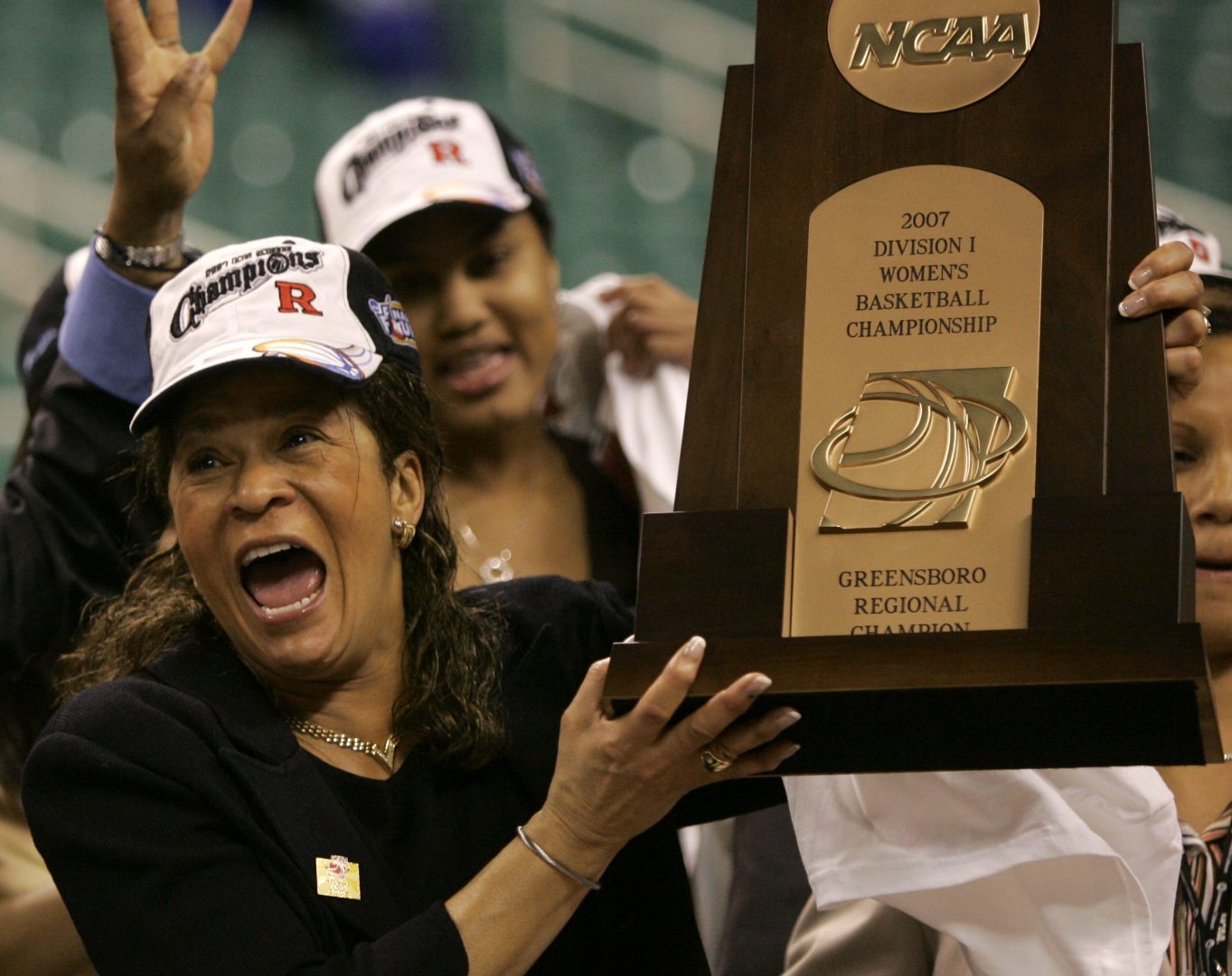 FiLE - Rutgers coach C. Vivian Stringer holds the trophy after Rutgers defeated Arizona State 64-45 in the regional final of the NCAA women's basketball tournament in Greensboro, N.C., Monday, March 26, 2007. Stringer has announced her retirement, Saturday, April 30, 2022, after 50 years in college basketball. She finished with 1,055 wins, fourth all-time among Division I women’s basketball coaches. (AP Photo/Mary Ann Chastain)