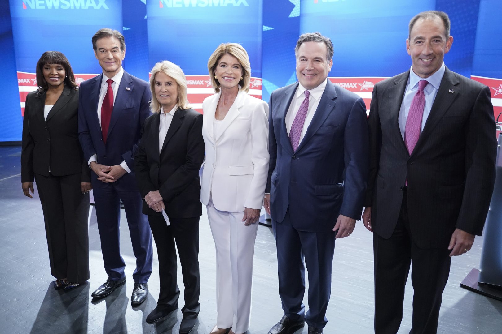 Kathy Barnette, Mehmet Oz, moderator Greta Van Susteren, Carla Sands, David McCormick, and Jeff Bartos, (left to right) pose for photo before they take part in a debate for Pennsylvania U.S. Senate Republican candidates, Wednesday, May 4, 2022, in Grove City, Pa. (AP Photo/Keith Srakocic)