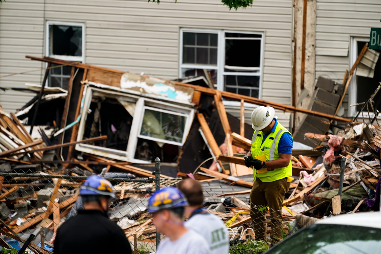 Investigators and utility crews work the scene of a deadly explosion in a residential neighborhood in Pottstown, Pa., Friday, May 27, 2022. A house exploded northwest of Philadelphia, killing several people and leaving  others injured, authorities said Friday.  (AP Photo/Matt Rourke)