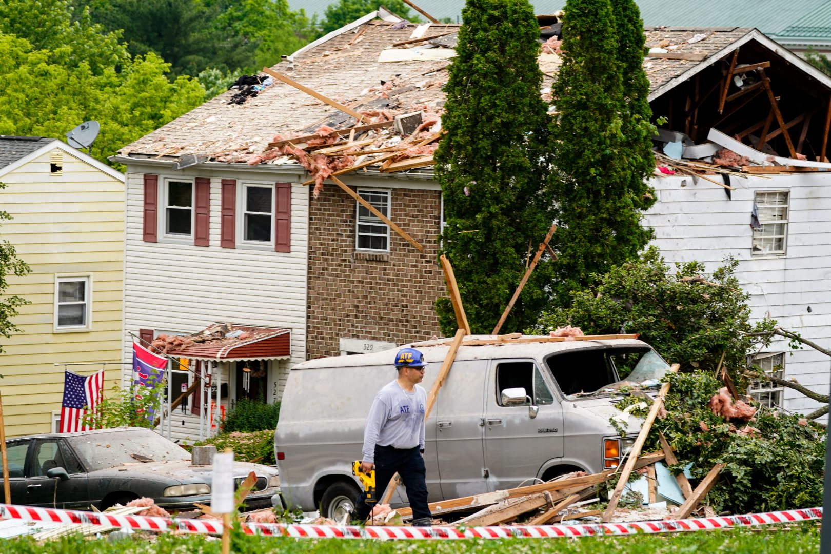 An investigator moves through the scene of a deadly explosion in a residential neighborhood in Pottstown, Pa., Friday, May 27, 2022. (AP Photo/Matt Rourke)