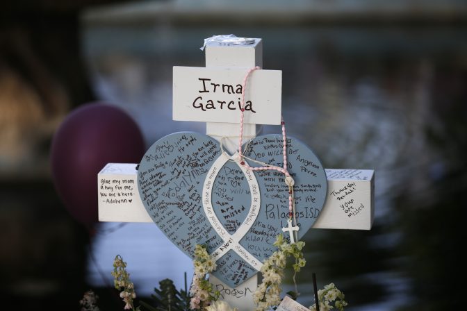 Irma Garcia's cross stands at a memorial site for the victims killed in this week's shooting at Robb Elementary School in Uvalde, Texas, Friday, May 27, 2022.
