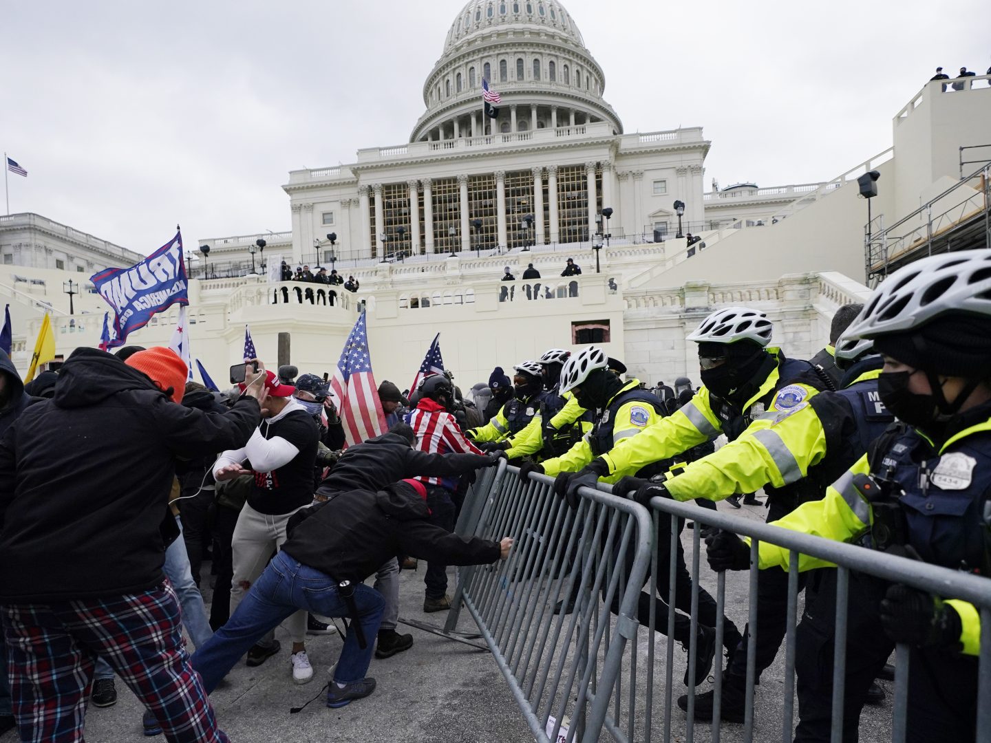 FILE - Trump supporters try to break through a police barrier at the Capitol in Washington on Jan. 6, 2021. An Alabama man who parked a pickup truck filled with weapons and Molotov cocktail components near the U.S. Capitol on the day of last year's riot was sentenced Friday, April 1, 2022, to nearly four years in prison. (AP Photo/Julio Cortez, File)