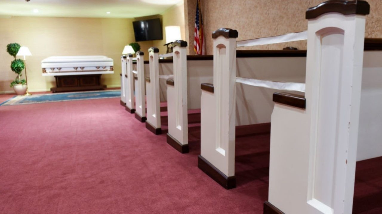 Temple, PA - March 2: A casket and pews with every other row marked off to encourage social distancing in the funeral home. At the Milkins Trymbiski Funeral Home on Kutztown Road in Temple, PA Tuesday morning March 2, 2021 