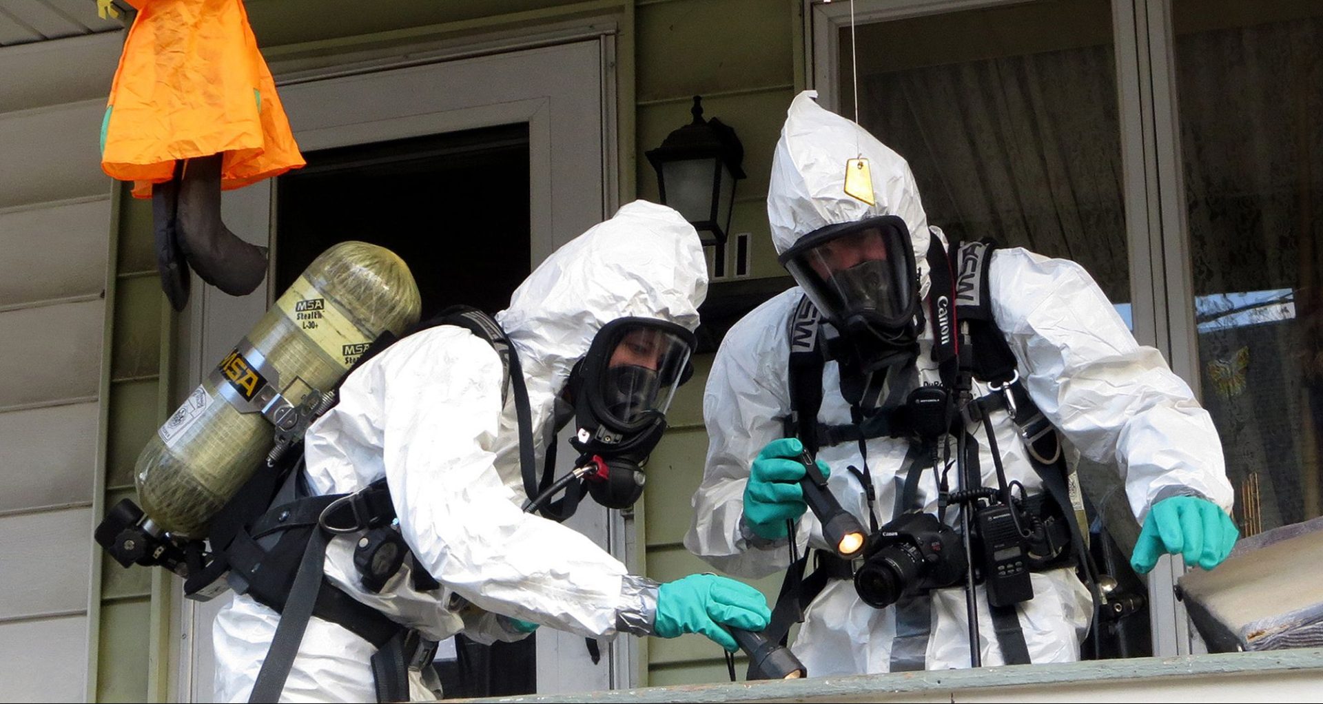 Members of the Pennsylvania State Police Clandestine Lab Response Team remove chemicals from the front porch of a home in Minersville in 2013.