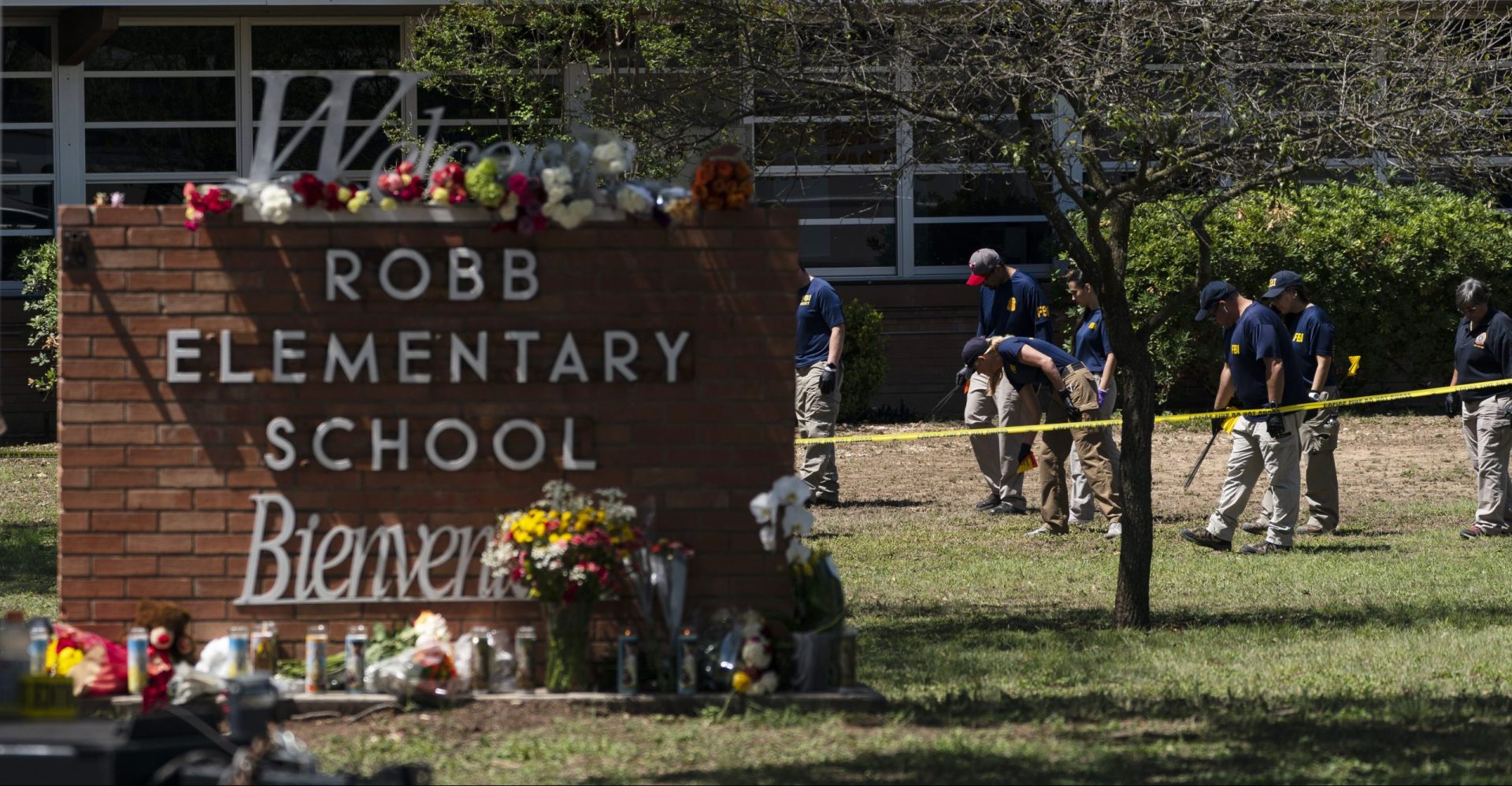 Investigators search for evidences outside Robb Elementary School in Uvalde, Texas, Wednesday, May 25, 2022. Desperation turned to heart-wrenching sorrow for families of grade schoolers killed after an 18-year-old gunman barricaded himself in their Texas classroom and began shooting, killing several fourth-graders and their teachers