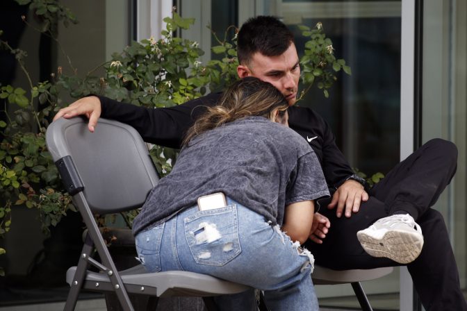 People wait outside of the Civic Center in Uvalde, Texas, Tuesday, May 24, 2022. An 18-year-old gunman opened fire at Robb Elementary School, killing multiple people.