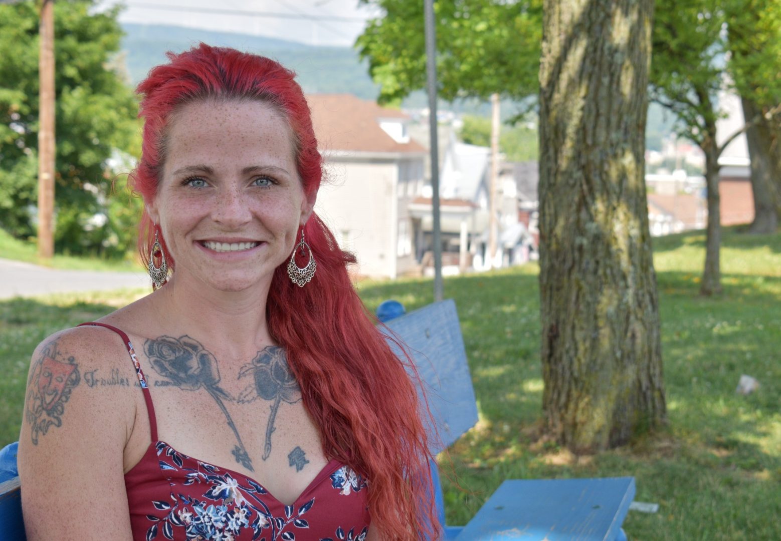 Katie Labus sits in the shade for a portrait at Prospect Park in Altoona. Labus, 31, was addicted to opioids and methamphetamine for 13 years. When she got pregnant, she was able to get help through a nurse family partnership program. 