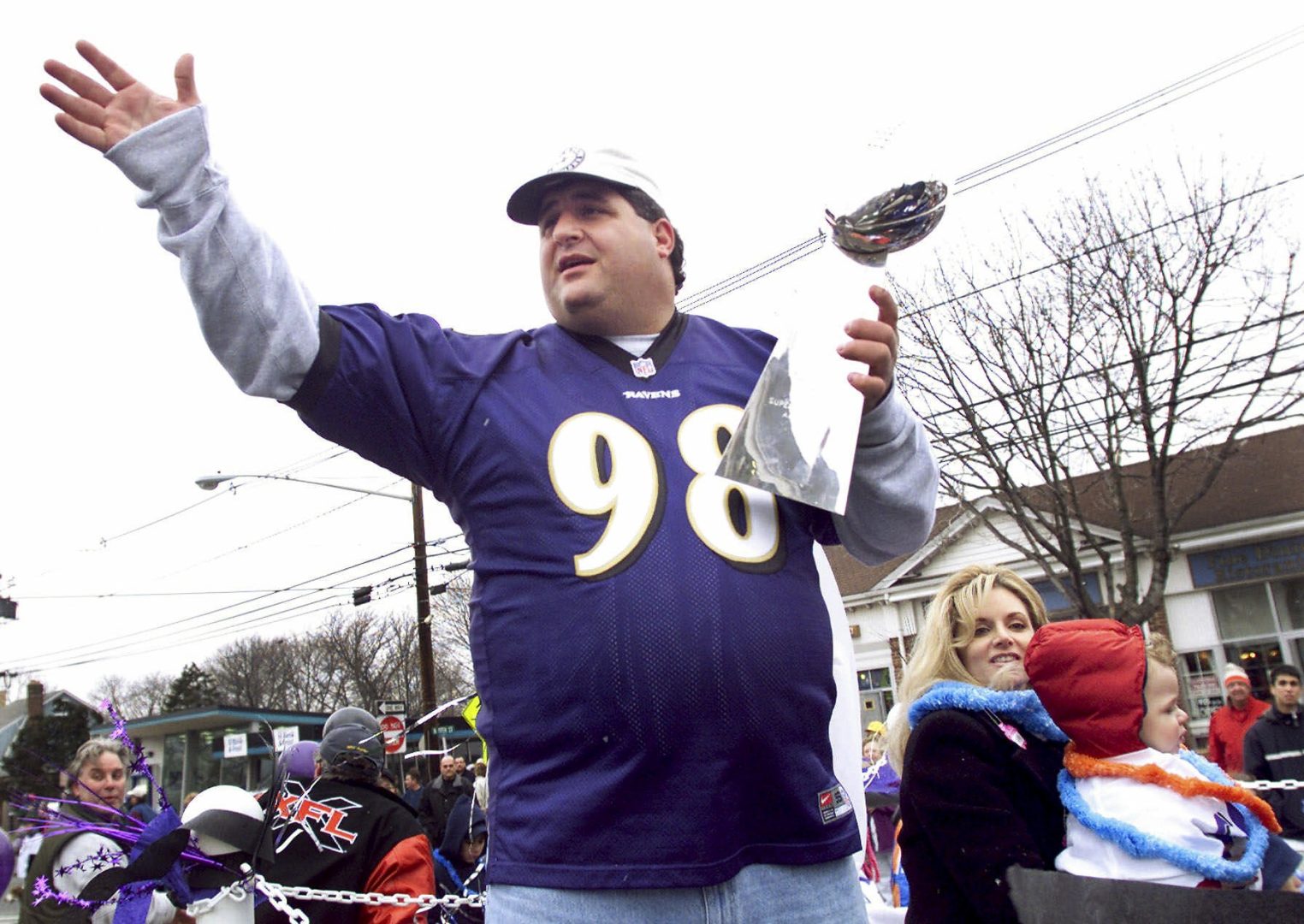 Tony Siragusa, defensive tackle for the Super Bowl-champion Baltimore Ravens, holds the Vince Lombardi trophy as he rides with his wife, Kathy, in a parade in his hometown of Kenilworth, N.J. on March 4, 2001. 